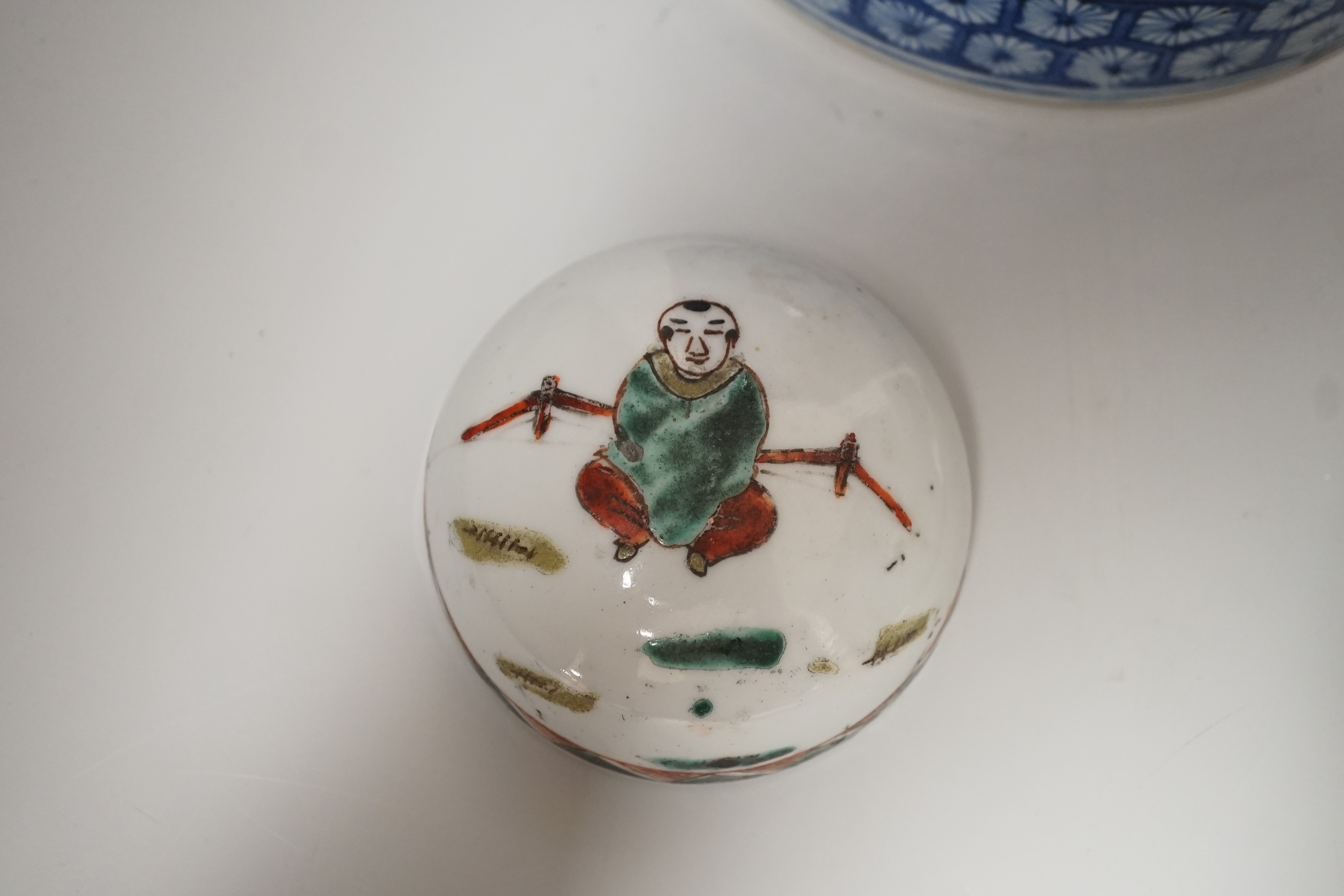 A Chinese blue and white brushpot, enamelled jar, brush pot, famille verte jar cover and a Japanese blue and white tea bowl and cover. Tallest 18cm